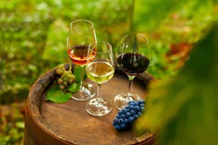 Wooden barrel with wine glasses in the vineyard