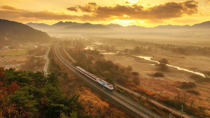 korail-regional-travel-autumn-train 노을이 비치는 강과 산 사이 철로를 달리는 관광열차